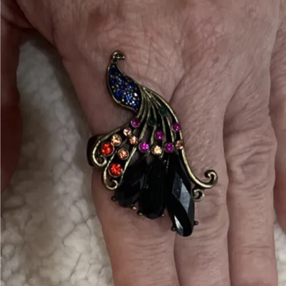 Gold tone peacock stretch ring with blue red pink peach rhinestones. Size 8